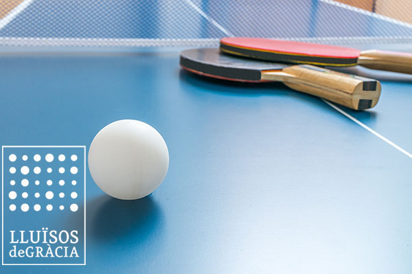 White ball for table tennis or ping pong on wooden table.